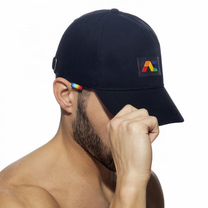 Black baseball cap ad rainbow cap with rainbow-colored logo patch and matching stripe on ear flap
