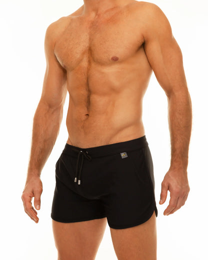 Black along slit swim short trunks with drawstring waistband and small metallic logo on the side