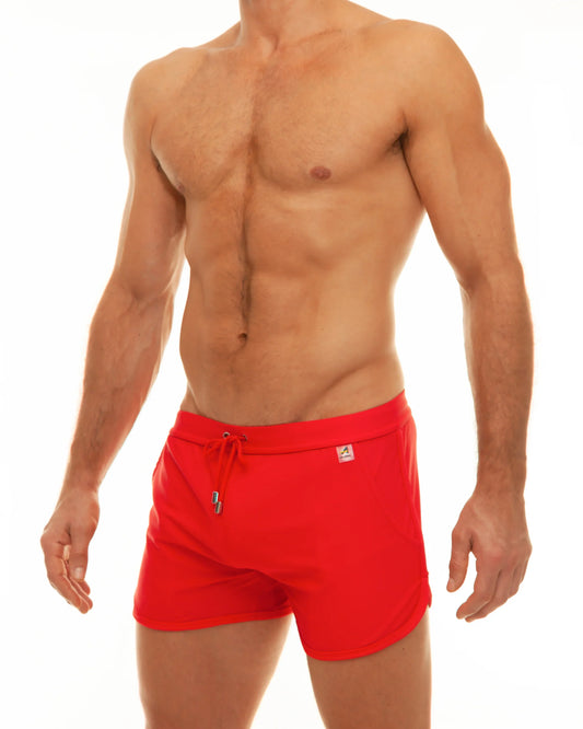 Along slit swim short bright red swim trunks with drawstring waistband and small logo patch on the side