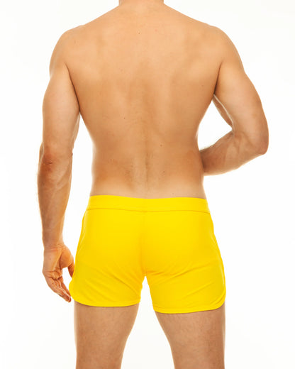 Bright yellow along slit swim short swim trunks with a smooth fitted design perfect for swimming and beachwear