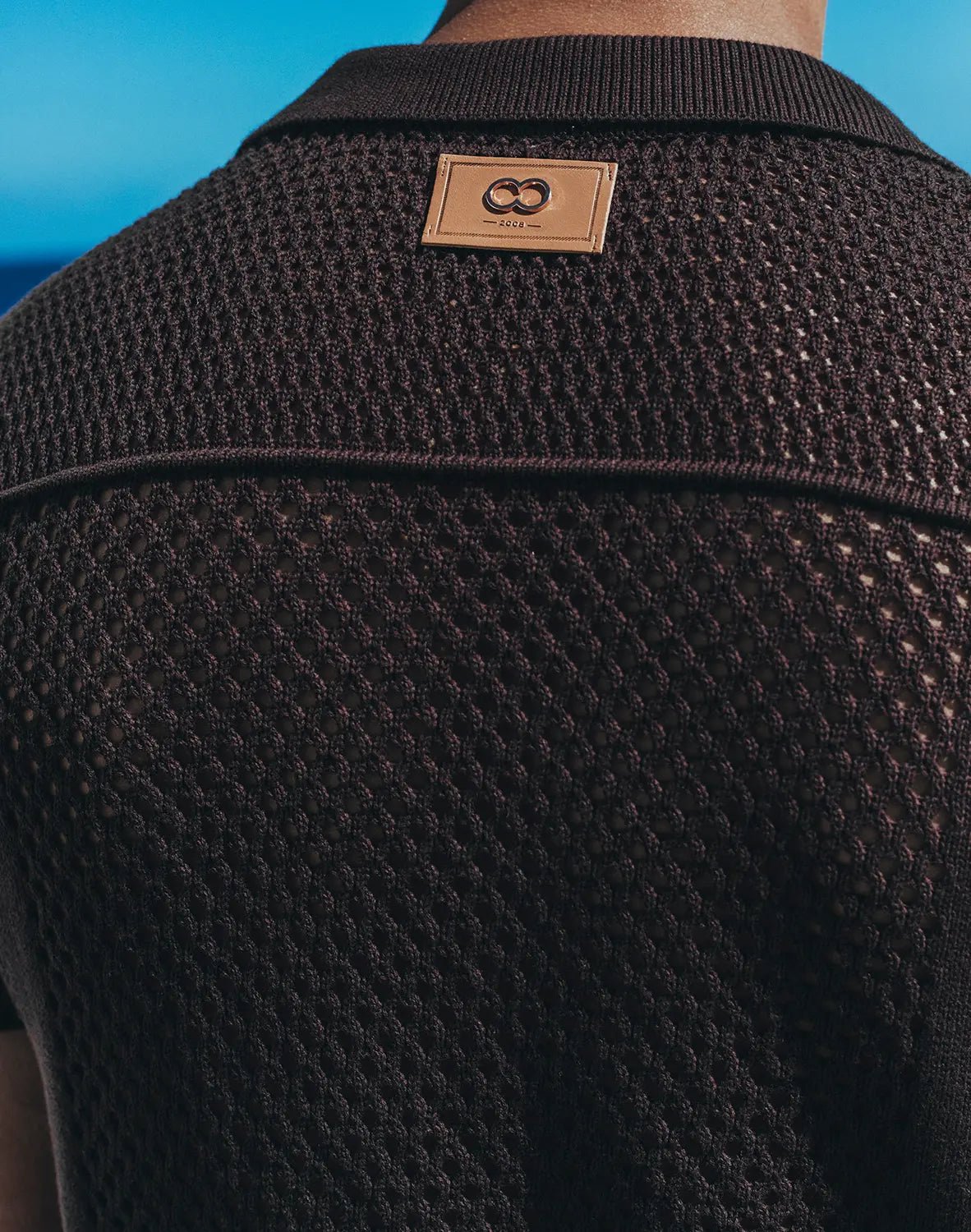 Amafi knit shirt black textured knit polo with tan leather patch and interlocking double o logo