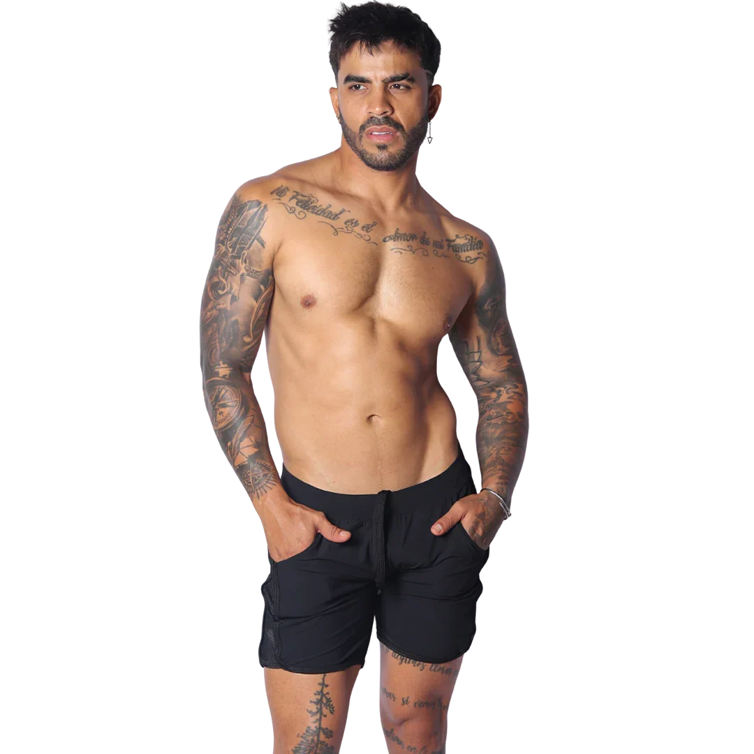 Athletic black shorts with side pockets, a drawstring waistband, and mesh panels, modeled on a fit man.