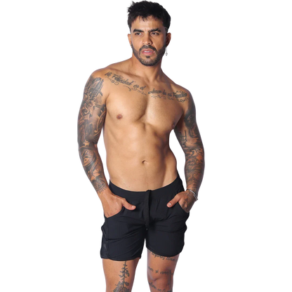 Athletic black shorts with side pockets, a drawstring waistband, and mesh panels, modeled on a fit man.