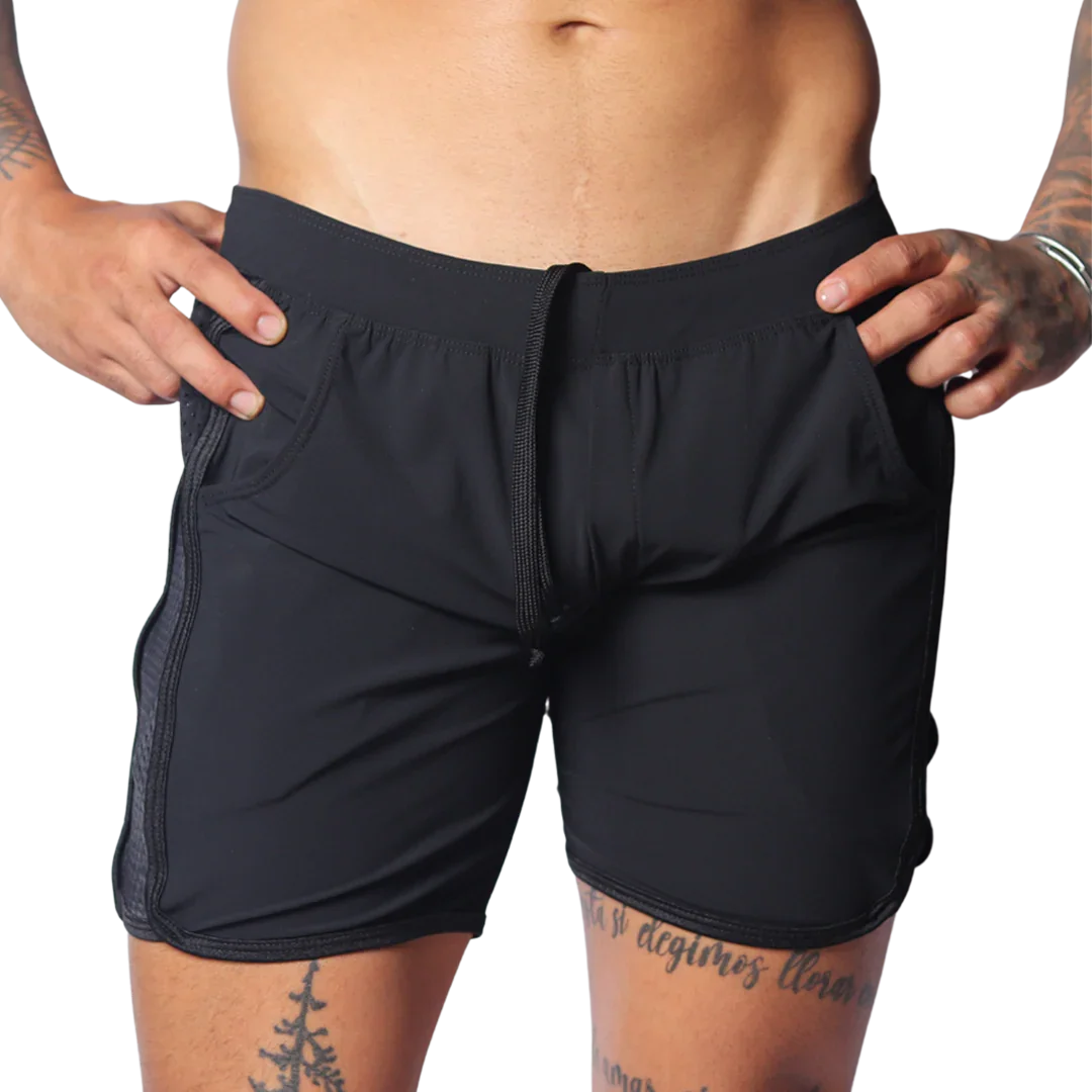 Black athletic shorts with an elastic drawstring waist, side pockets, and perforated panels on the side seams.