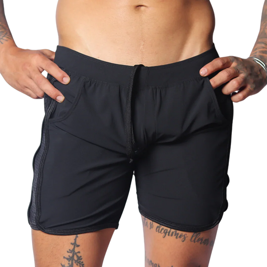 Black athletic shorts with an elastic drawstring waist, side pockets, and perforated panels on the side seams.