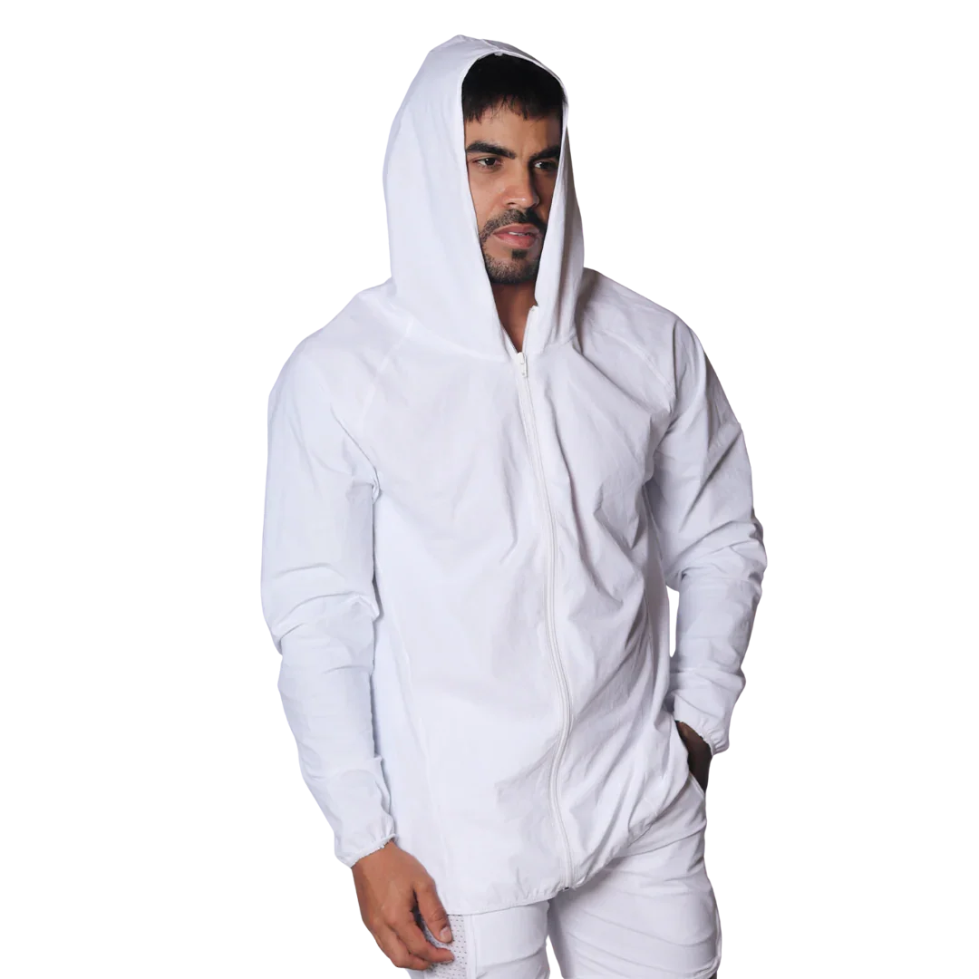Minimalist white hooded windbreaker jacket with a front zipper and long sleeves, worn by a man against a black backdrop.