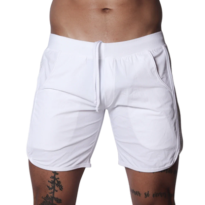 White athletic shorts featuring an elastic waistband with drawstring, side pockets, and curved hem detail.