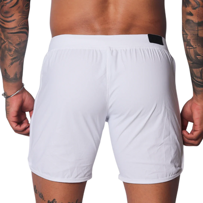 Plain white athletic shorts with a smooth, lightweight fabric, elastic waistband, and small black logo tab on the back.