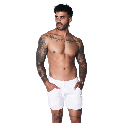 White athletic shorts featuring a drawstring waistband and side pockets on a tattooed model.