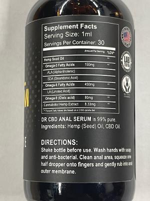 Dark amber glass bottle of dr cbd anal serum with black label, white text, american flag, containing 95% pure hemp seed oil