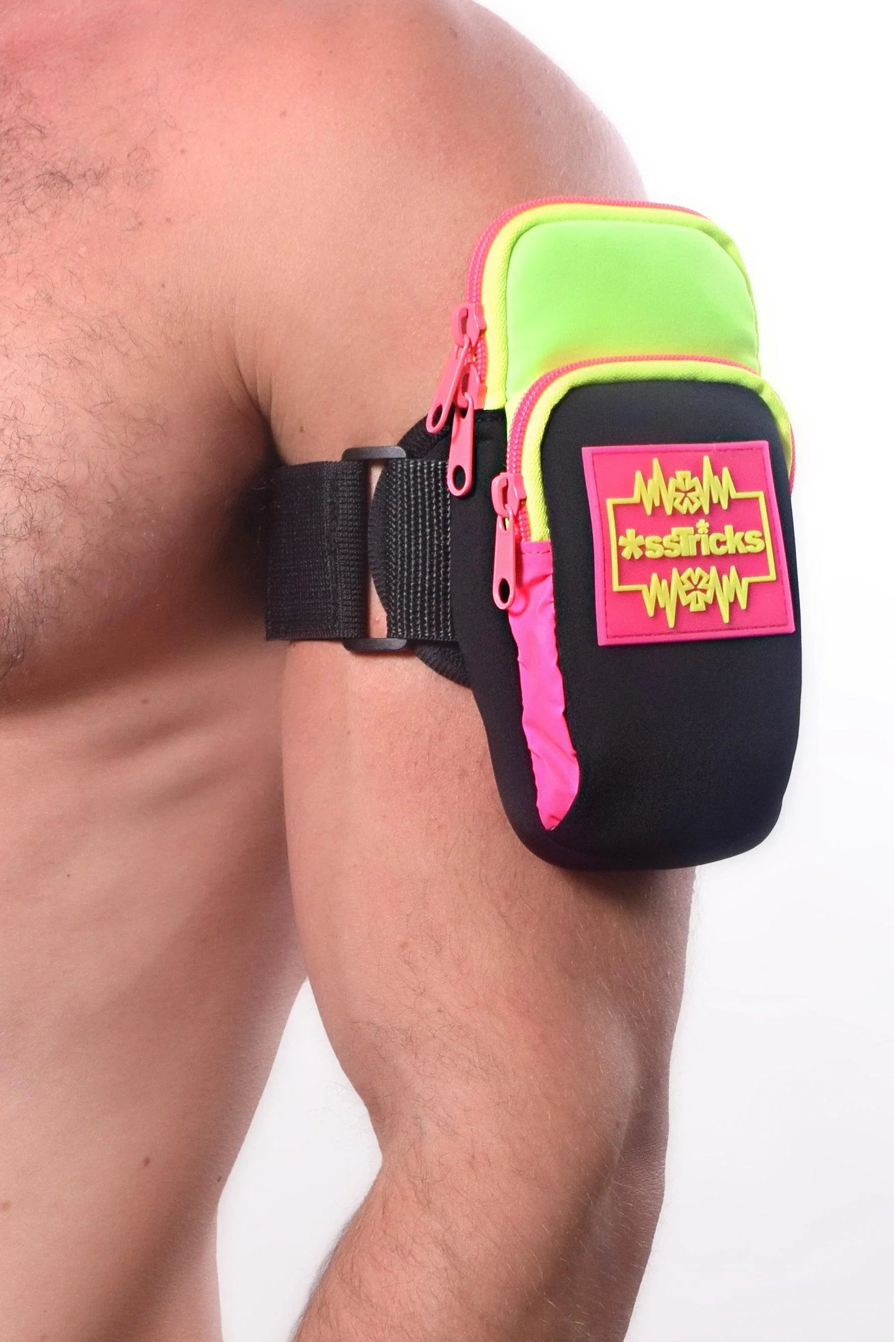 Neon green and pink arm bag with black straps featuring bold m*sssticks logo patch for athletic use