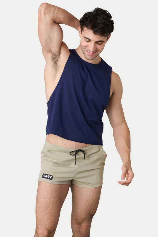 Front view of a person wearing a navy blue crop tank top and beige shorts.