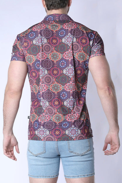 A man wearing a balboa button down shirt with a colorful purple pink and green mandala pattern on dark maroon fabric
