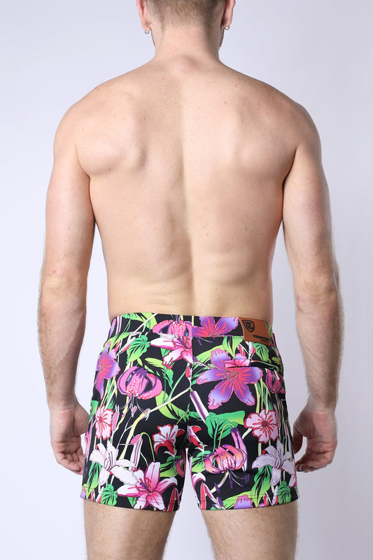 Balboa hybrid swim short featuring vibrant floral-patterned swim trunks in bold pink purple and green on black background
