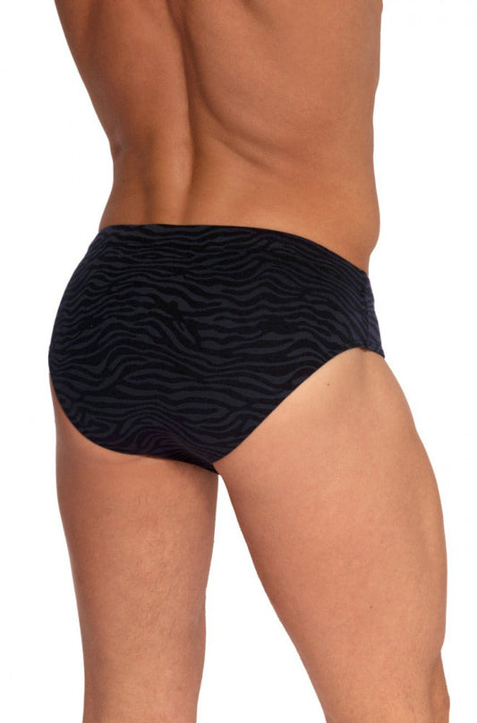 Rear view of a person wearing black swimwear briefs with a subtle grey animal stripe pattern on a white background.