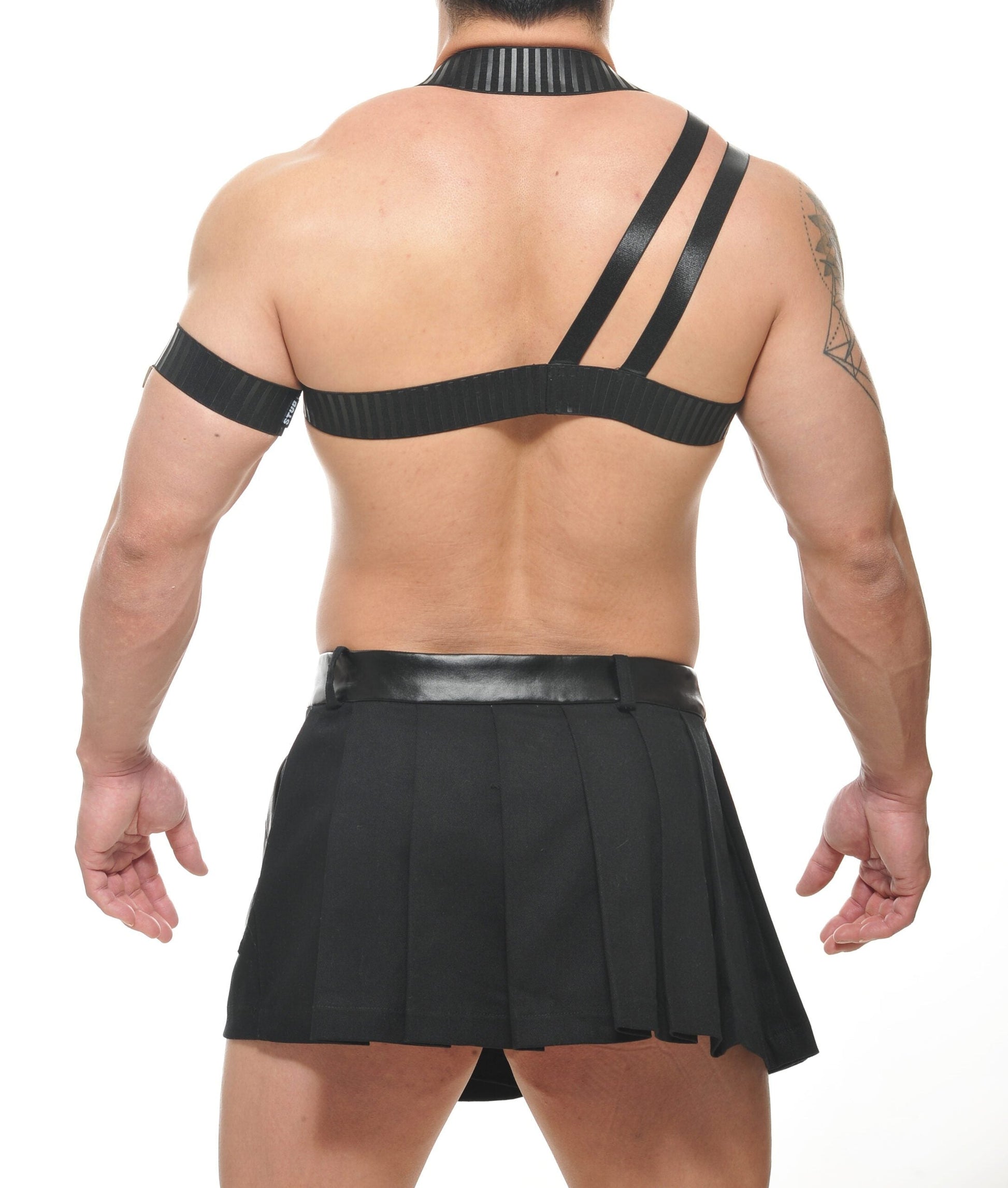 Black leather beta spartan harness with ribbed texture paired with matching pleated skirt front view