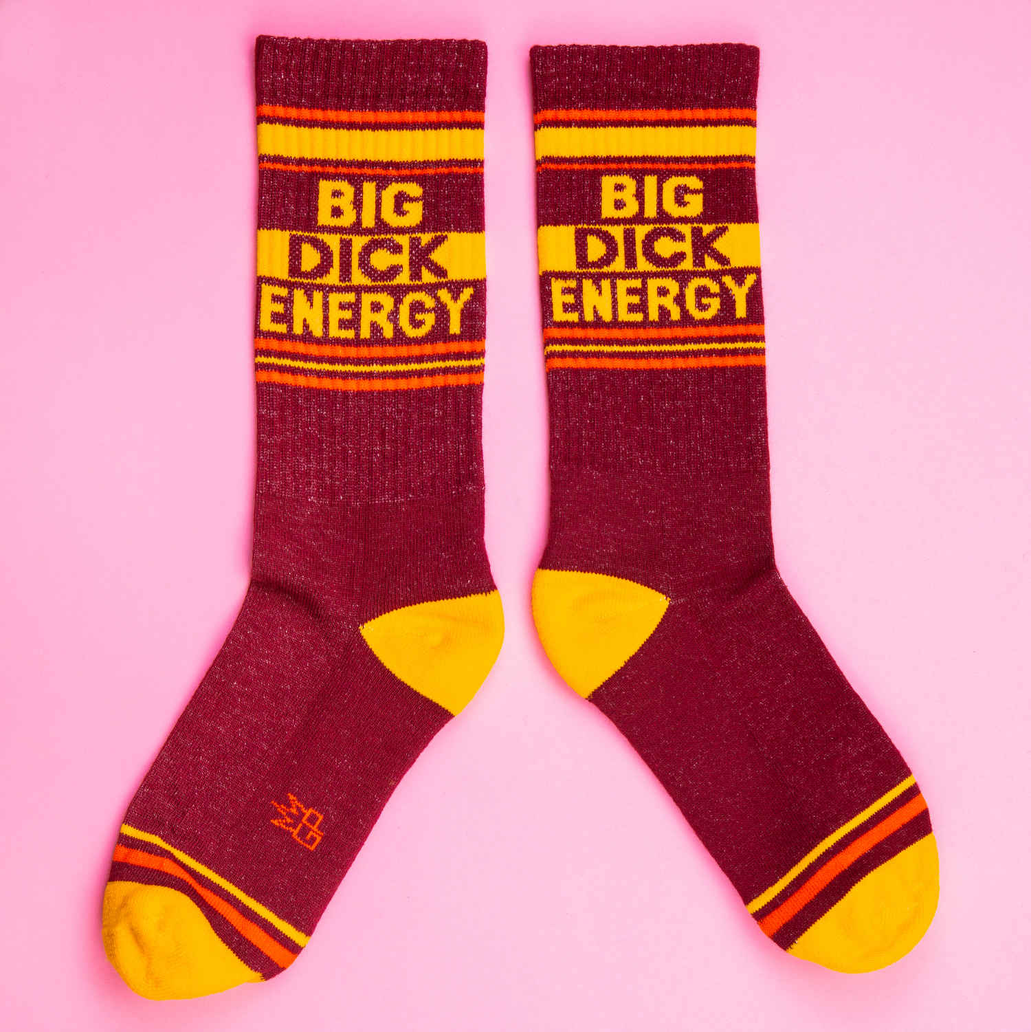 Maroon and yellow striped big dick energy crew socks made of textured knit material for bold style