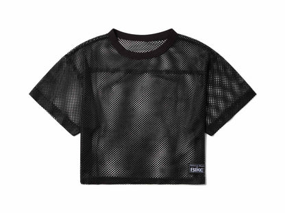 Black mesh crop top with round neckline short sleeves and small rectangular label on lower right side for bike practice jersey
