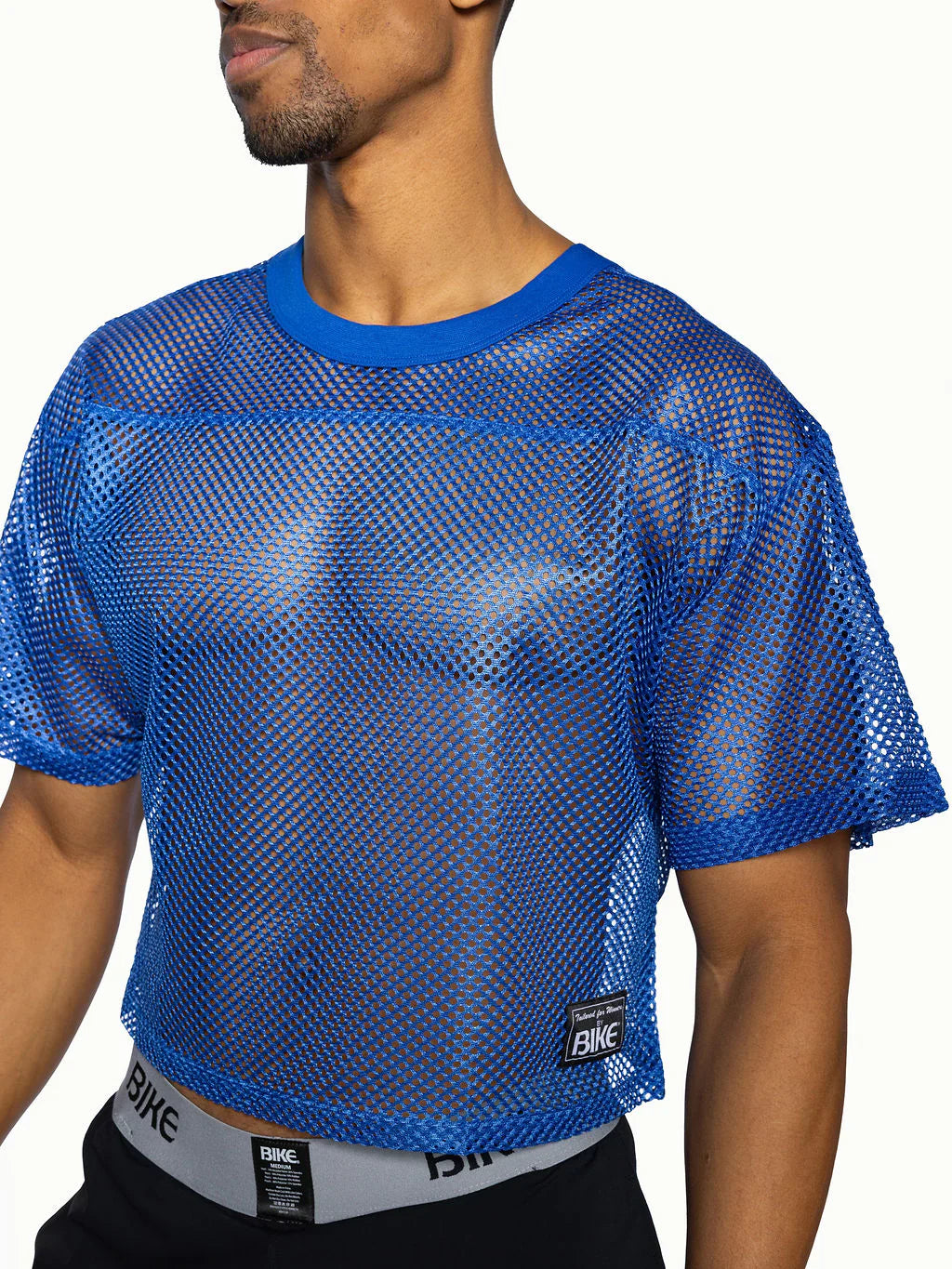 Bike practice jersey blue mesh crop top with solid blue ribbed neckline and sleeve cuffs for athletic wear