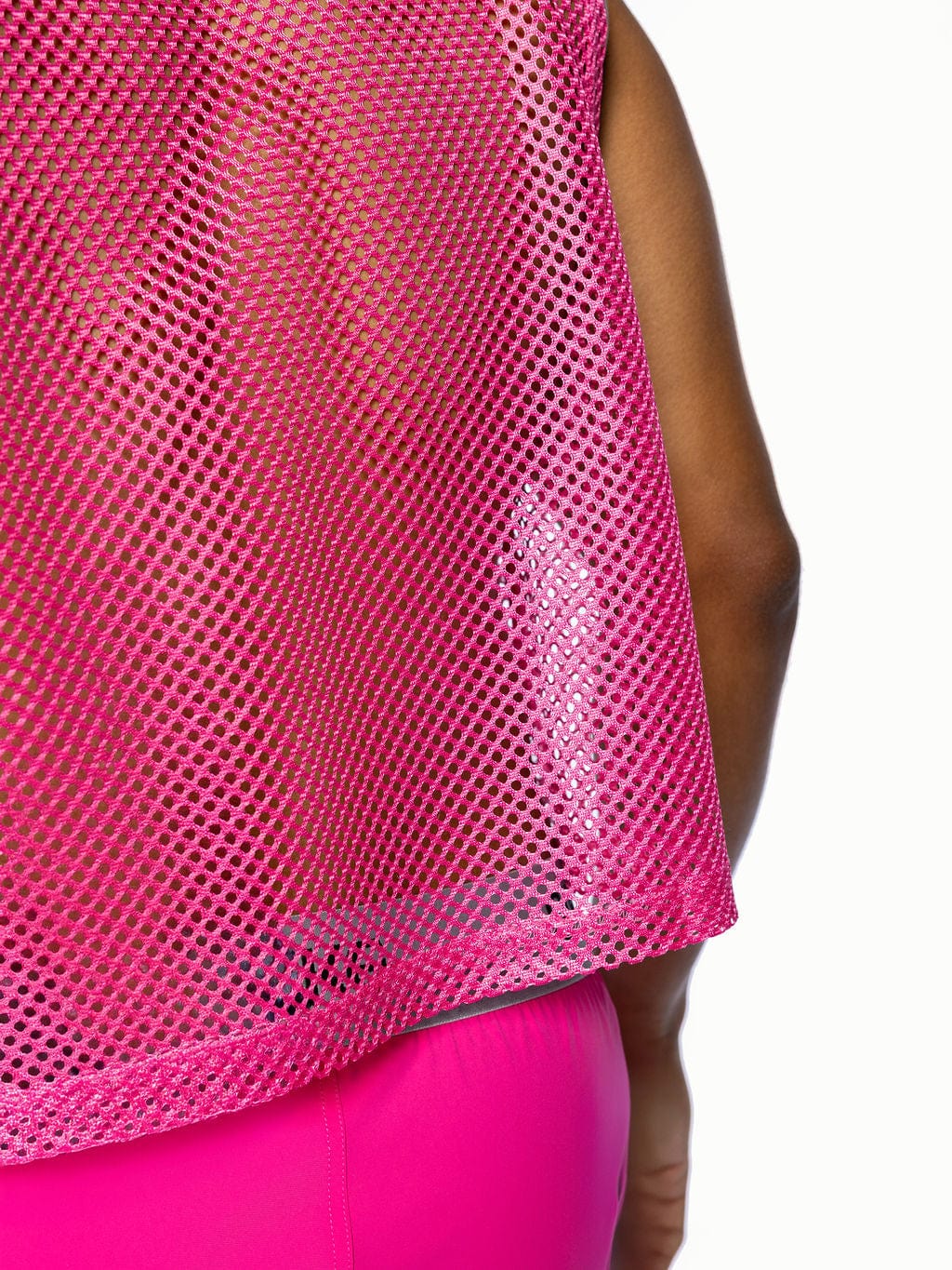 A vibrant pink bike sleeveless practice jersey with breathable mesh fabric and a slightly flared hem