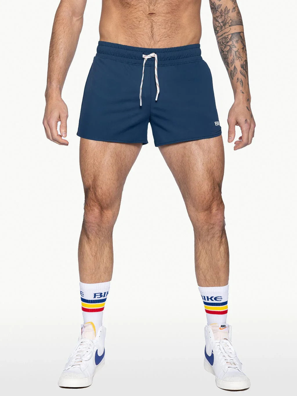 Navy blue bike track shorts with white drawstrings and a small logo on the lower right leg for athletic use