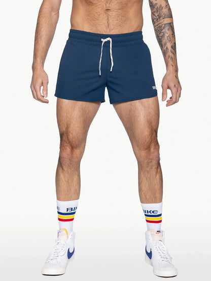 Navy blue bike track shorts with white drawstrings and a small logo on the lower right leg for athletic use