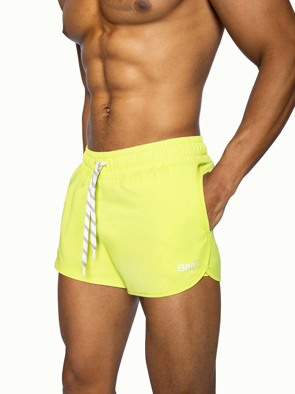 Bike track short in bright neon yellow with white striped drawstring and subtle logo on lower right leg