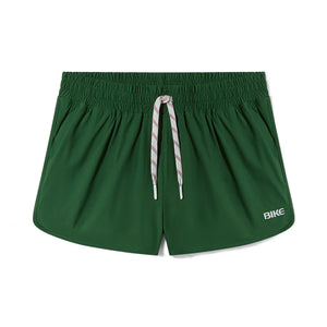 Green BIKE athletic track shorts with white drawstring and logo on the left leg.
