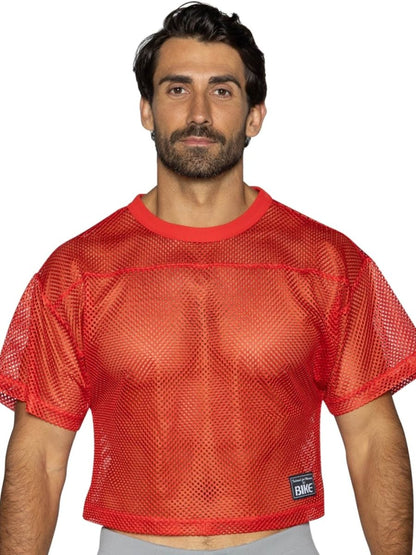 Red mesh crop top with solid red ribbed neckline and hem with black bike patch in bright red for athletic practice