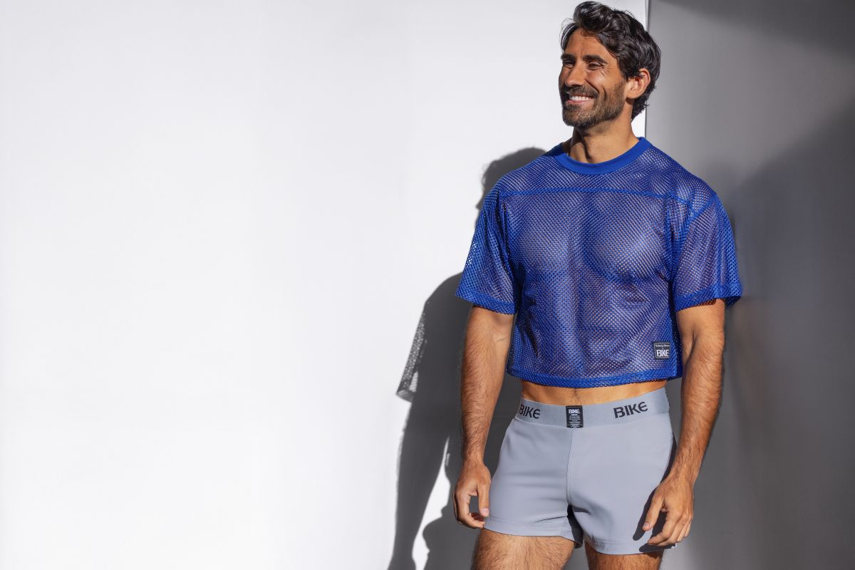 Blue mesh crop top with subtle textured pattern and small black logo on lower left side in royal color for biking practice