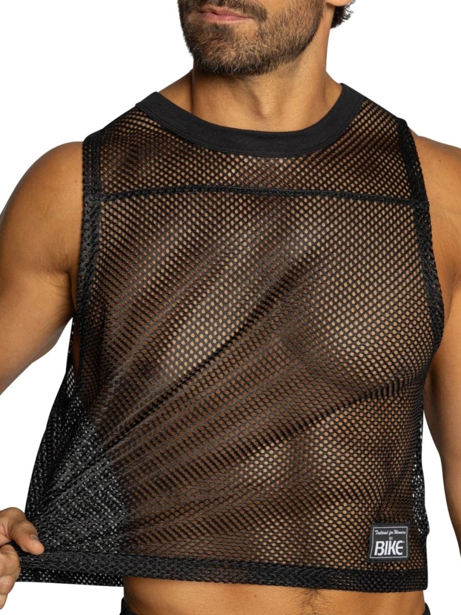 Black mesh crop top with solid black ribbed neckline and hem featuring a small label for athletic use