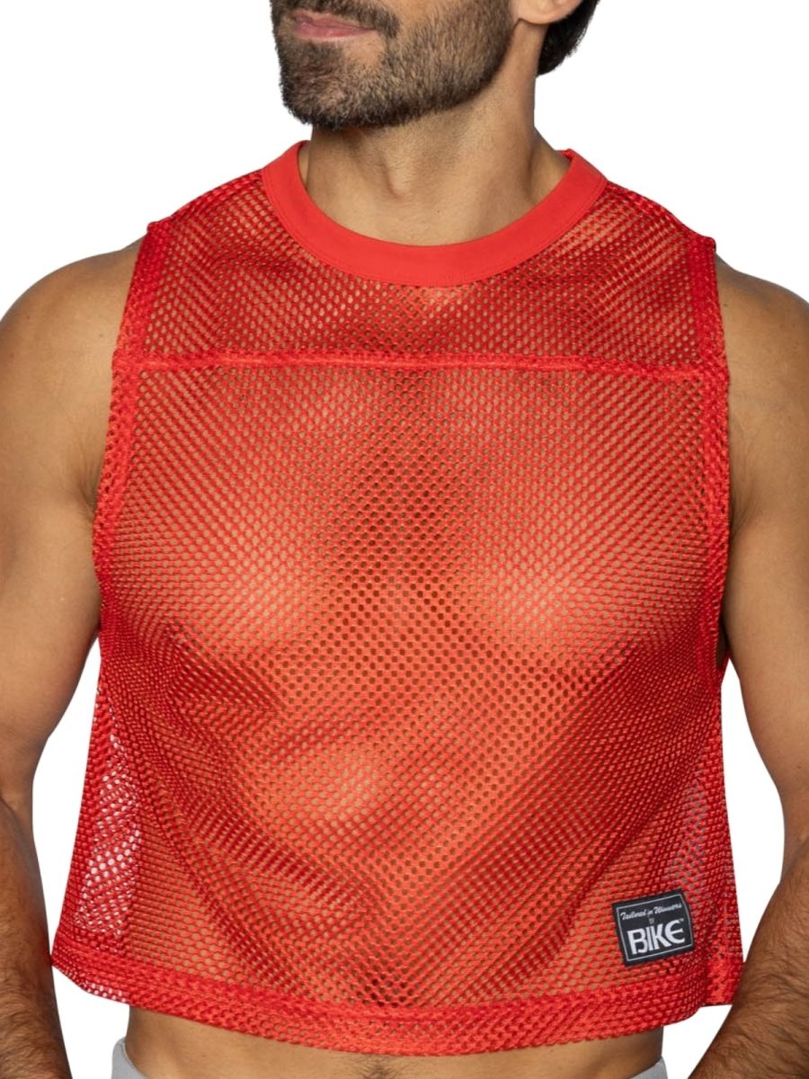 Red mesh crop top with solid red ribbed neckline and hem featuring black bike brand patch on lower right side