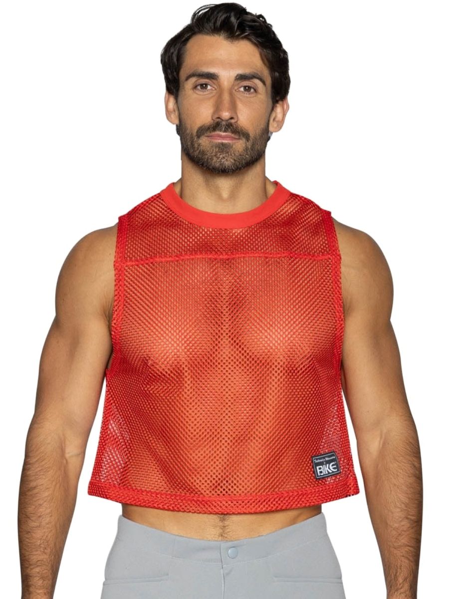 Red mesh crop top with ribbed neckline and hem featuring small black bike brand patch on lower right side for athletic use