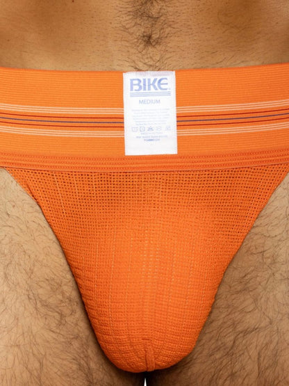 Orange BIKE athletic jockstrap with a textured pouch and striped waistband.