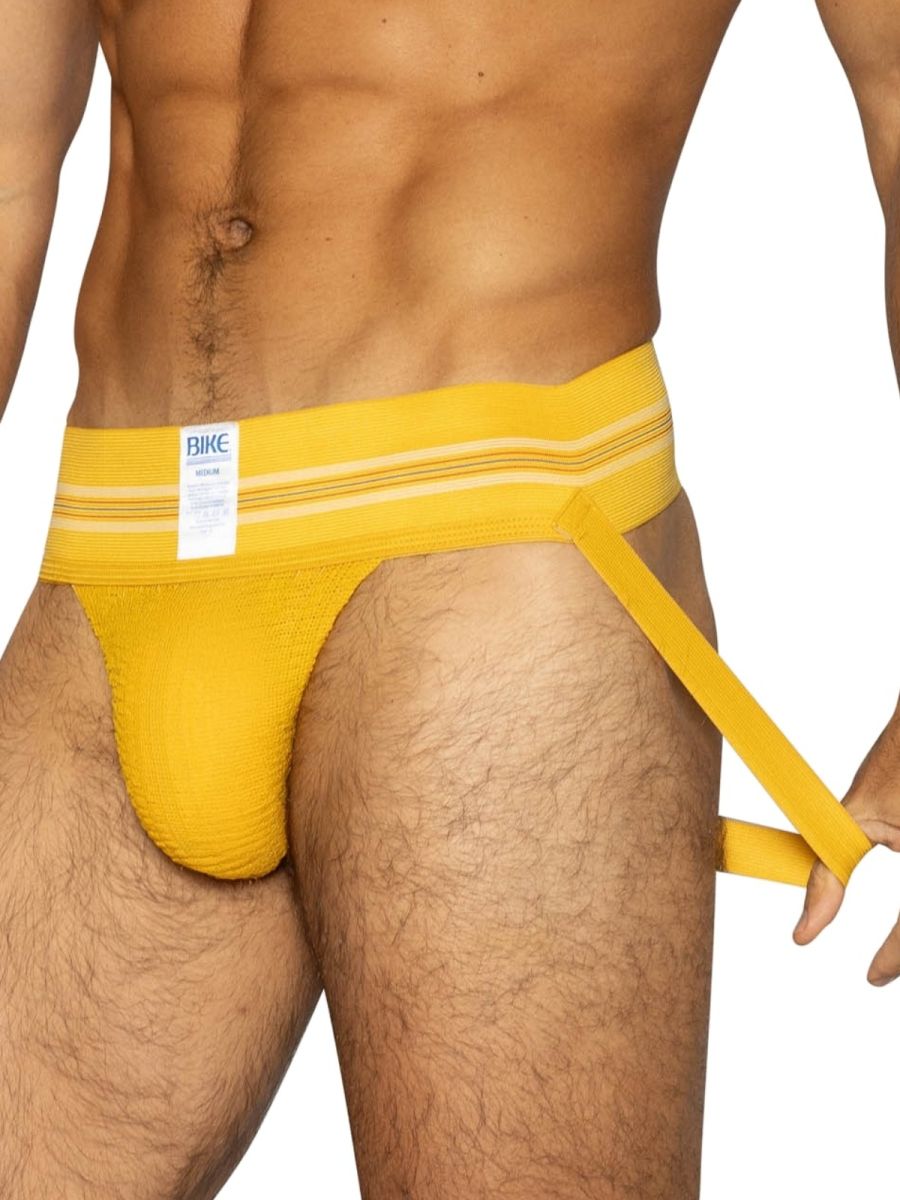 Bright yellow textured fabric bike brief with white bike label on waistband for athletic use and style