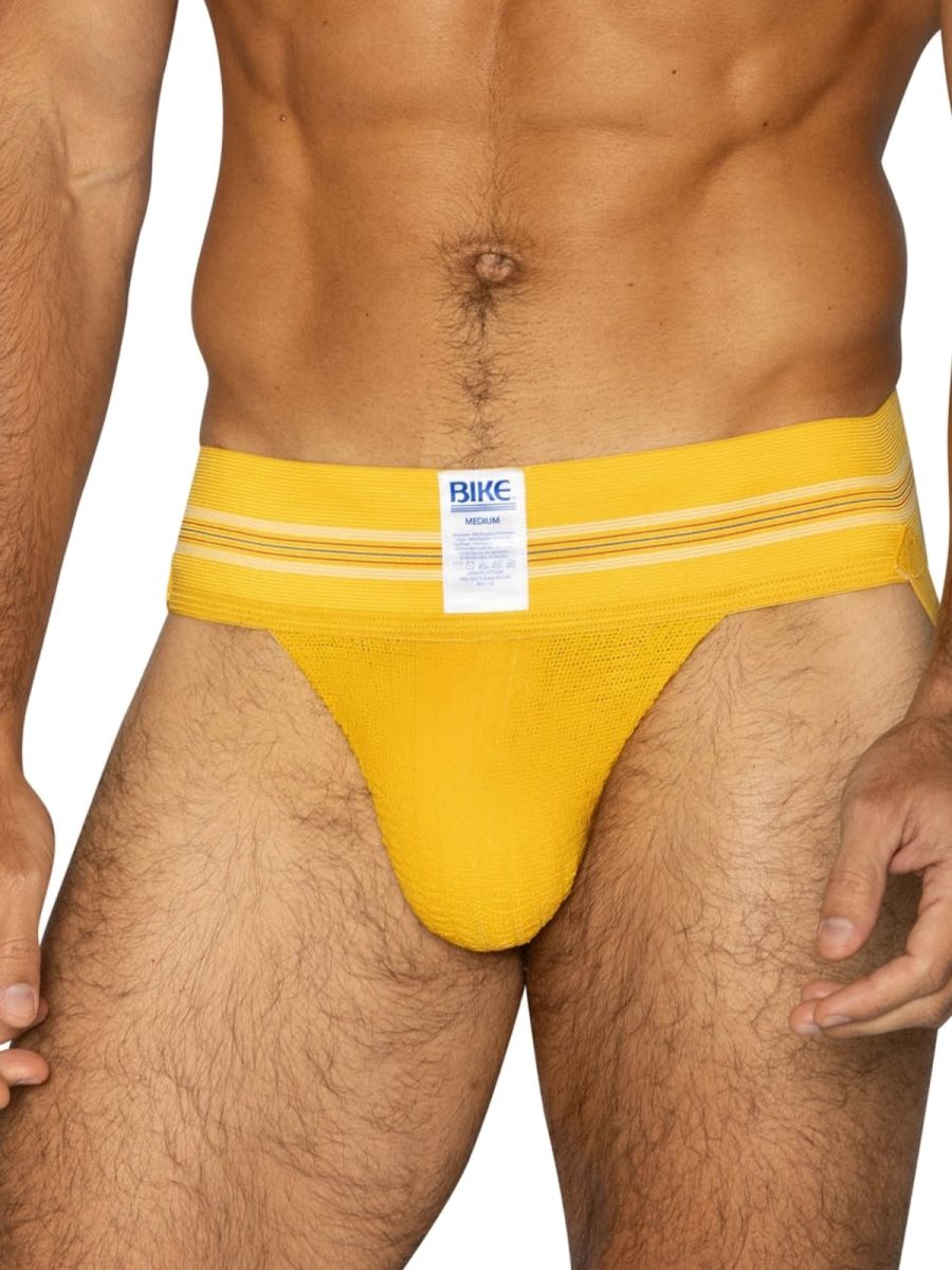 Bright yellow textured fabric bike brief with white stripes and bike brand label for athletic use