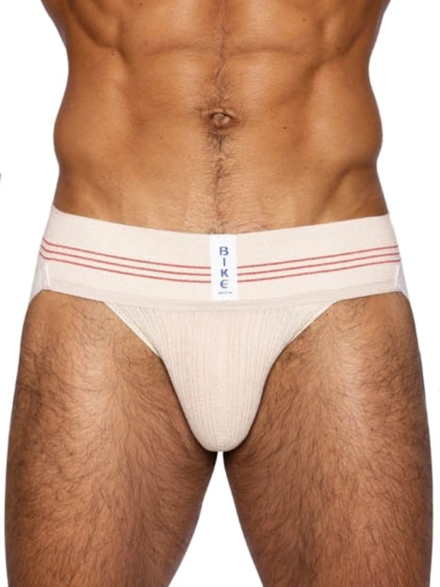 Cream-colored bike athletic briefs with red stripes and a white label in vintage cream classic retro style