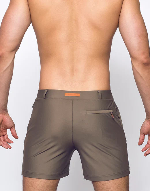 Olive green bondi shorts with subtle orange belt loop and zipper pocket detail for casual wear