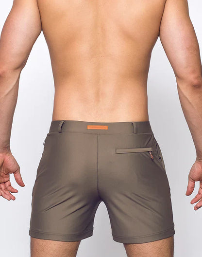 Olive green bondi shorts with subtle orange belt loop and zipper pocket detail for casual wear