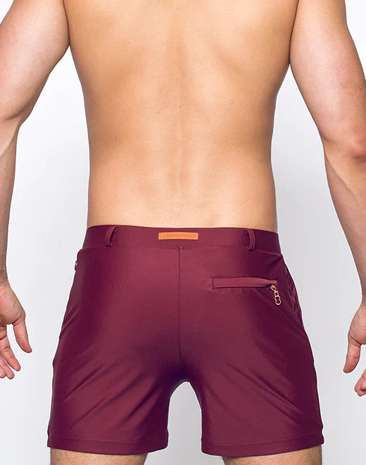 Maroon bondi short athletic shorts with subtle textured finish and orange rectangular brand tag at waistband