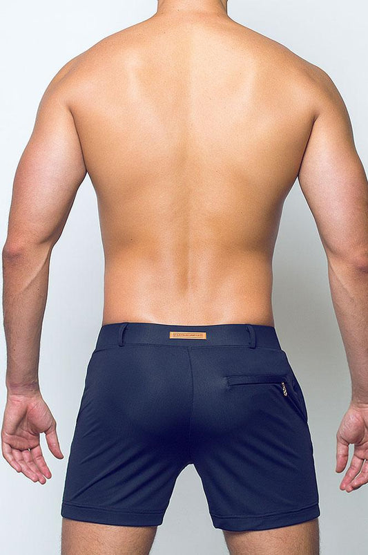 Navy blue bondi short with subtle textured fabric and a small brown leather patch at the waistband