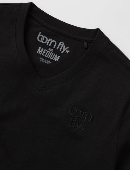 Black cotton born fly v-neck tee with subtle logo embroidery on chest and tagline printed inside collar