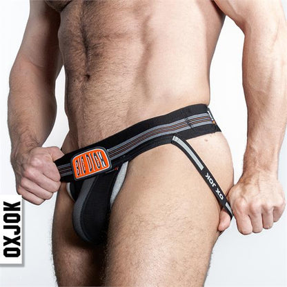 Black oxjok bulger jockstrap briefs with big dick branding and orange gray striped accents front view