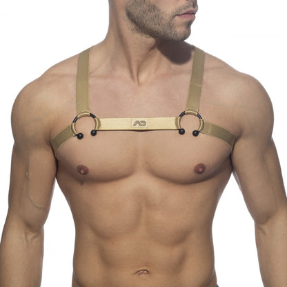 Gold-colored leather bull ring harness with black spherical accents and a central branded strap