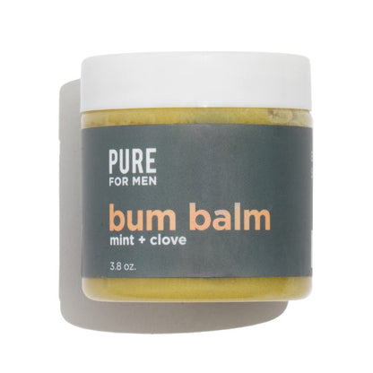 A matte white jar of pure for men bum balm mint and clove with a dark gray label and yellowish green balm inside