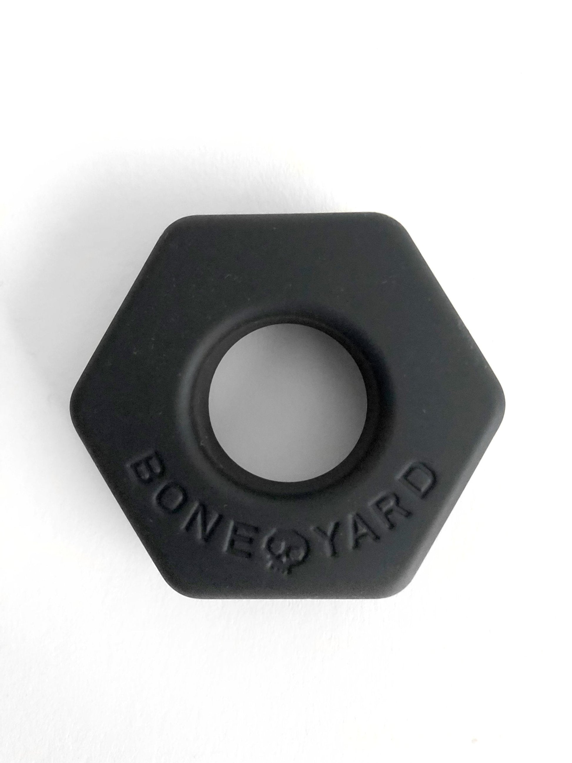 Black hexagonal silicone ring bust a nut with bone yard embossed around the center for comfortable everyday wear