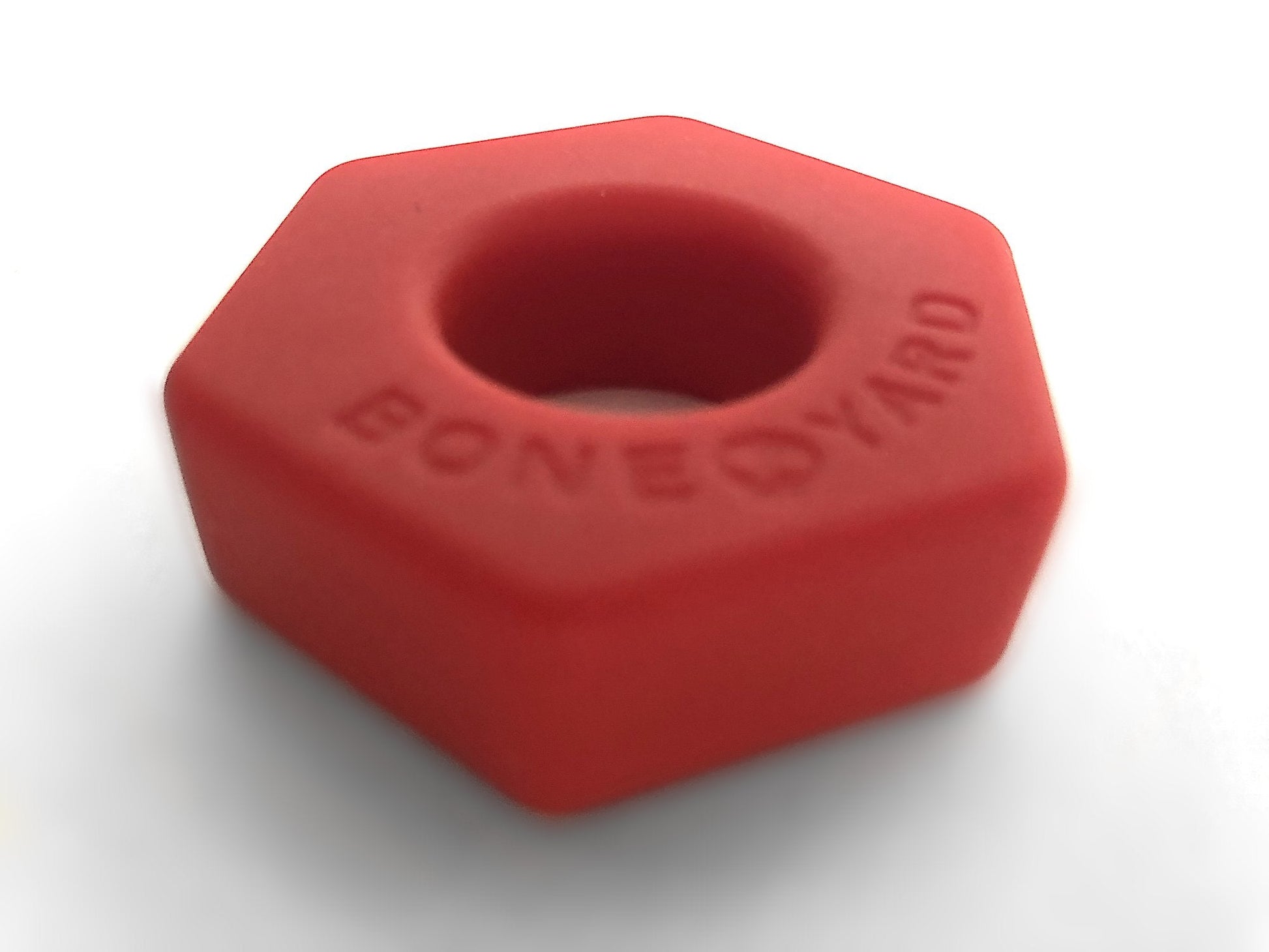 Red hexagonal silicone nut-shaped boneyard bust a nut stress relief toy with embossed logo on surface