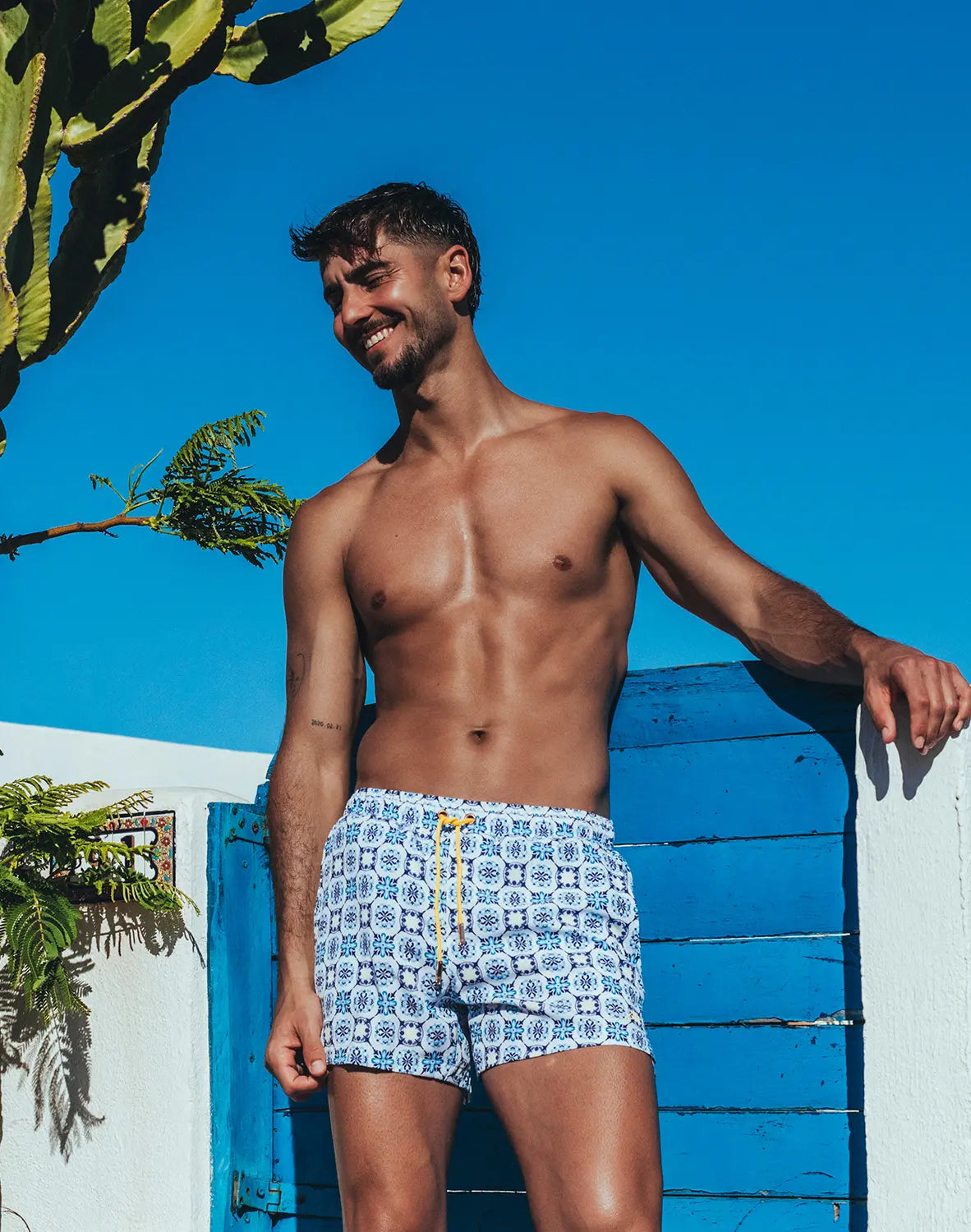 Byron swim short mykonos print white swim trunks with blue geometric pattern and yellow drawstring for beachwear