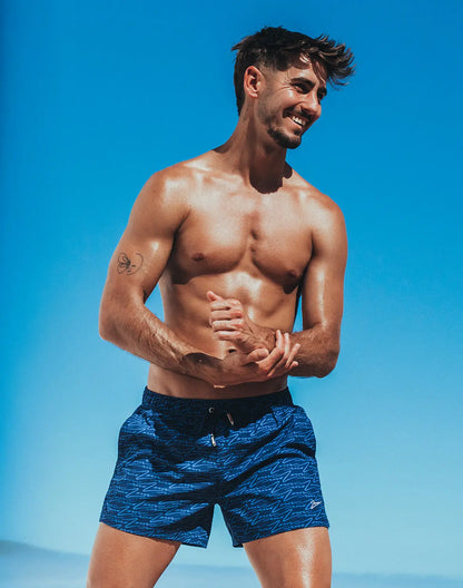 Byron swim short signature print featuring blue patterned swim trunks with subtle wave design and black waistband
