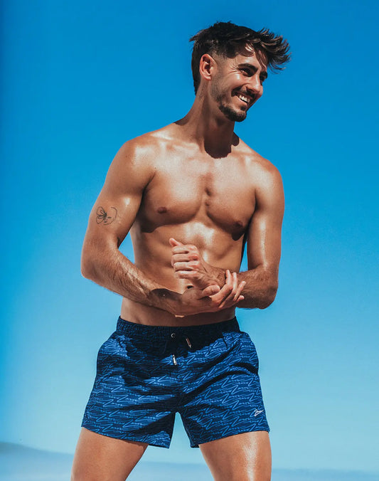 Byron swim short signature print featuring blue patterned swim trunks with subtle wave design and black waistband